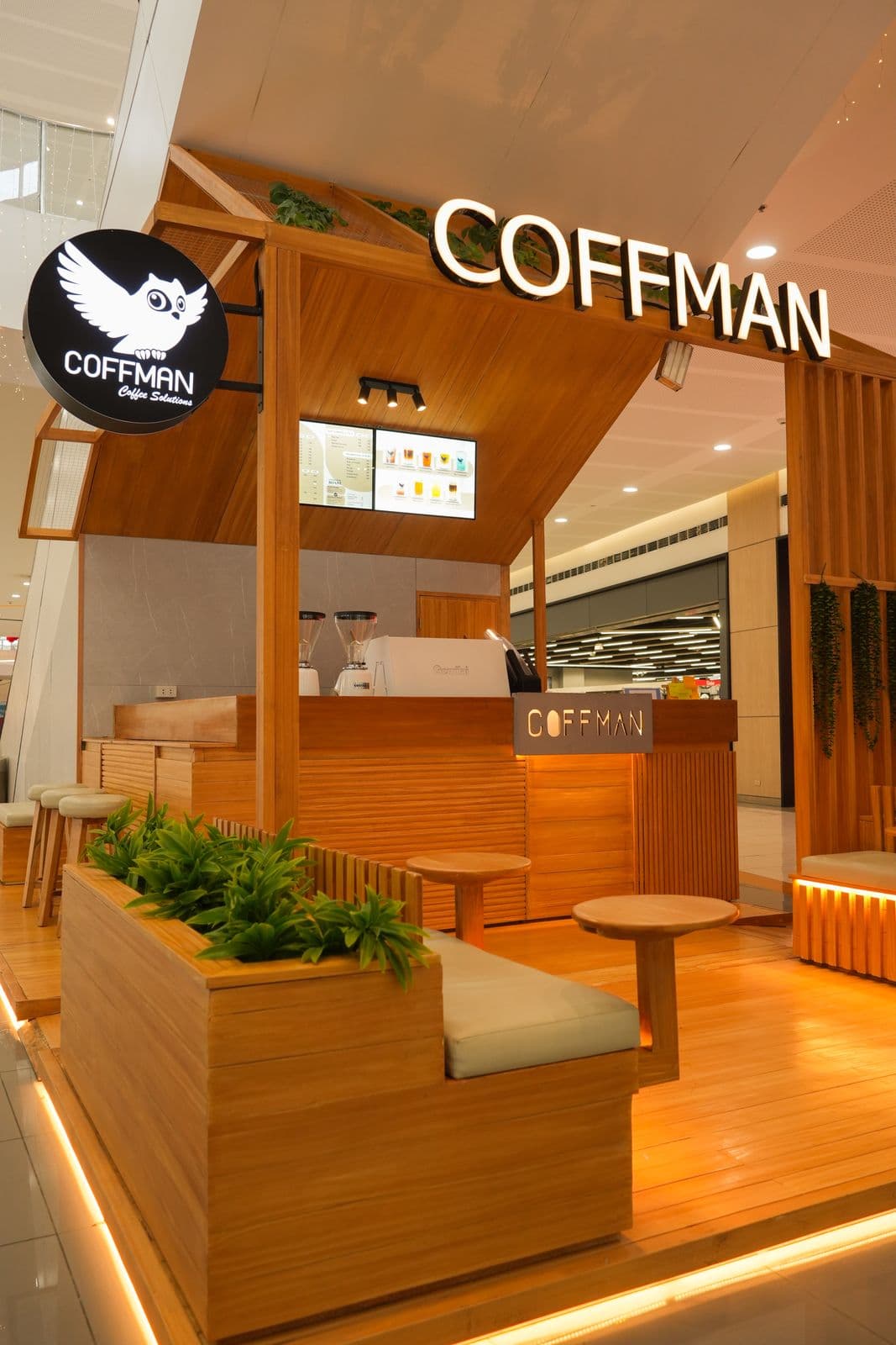 Coffman Coffee kiosk with custom timber cladding and LED lighting in a mall setting
