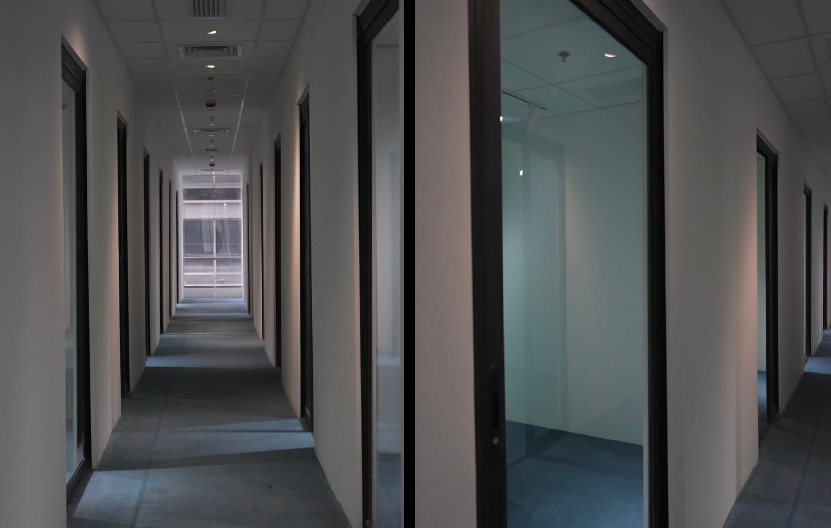 Etaily office corridor with glass-fronted rooms and green accent wall at the end