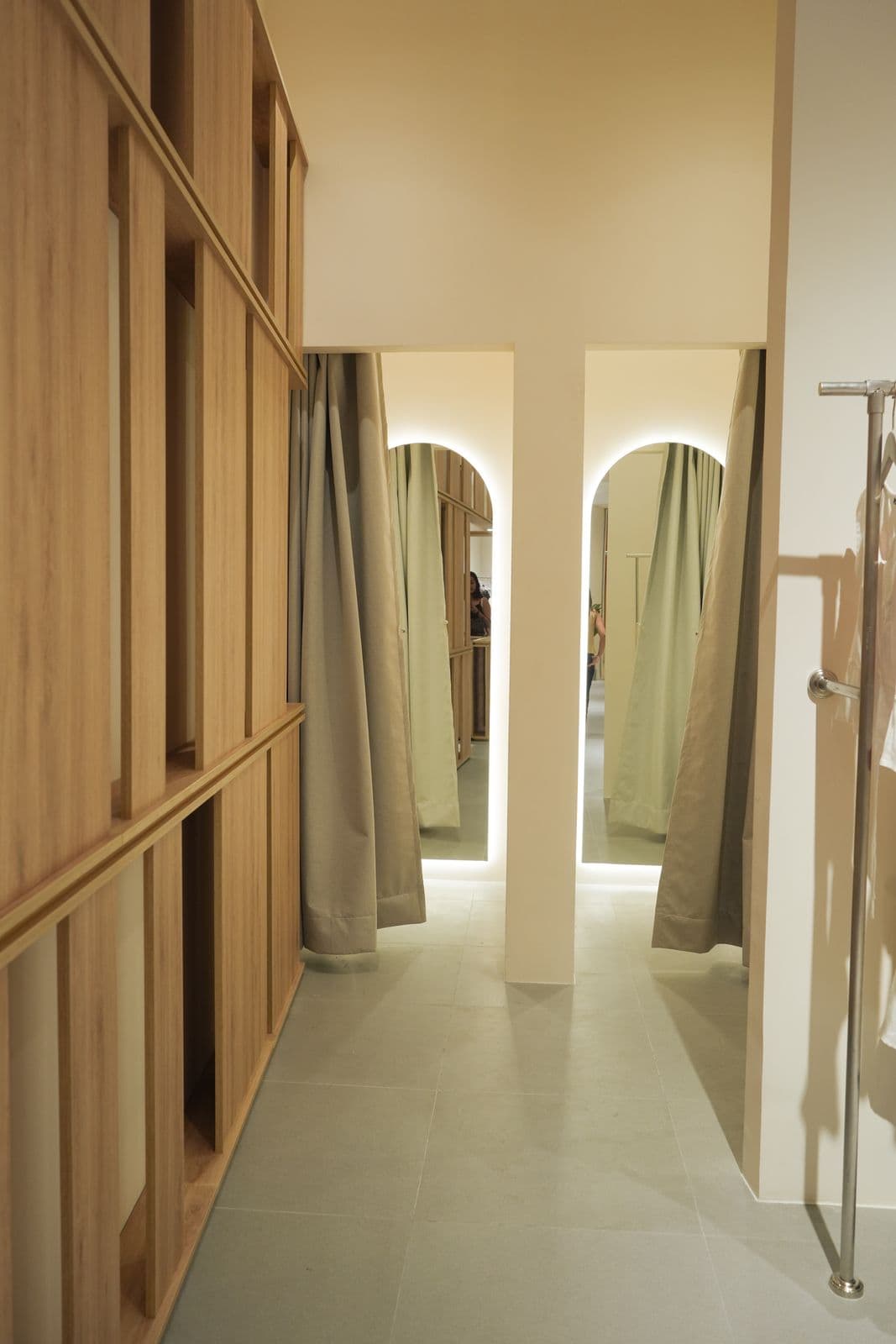 Interior of The Editor's Market with wood panel walls and garment display racks